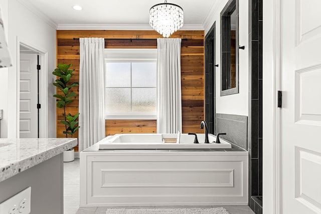bathroom featuring a notable chandelier, ornamental molding, a garden tub, and wooden walls