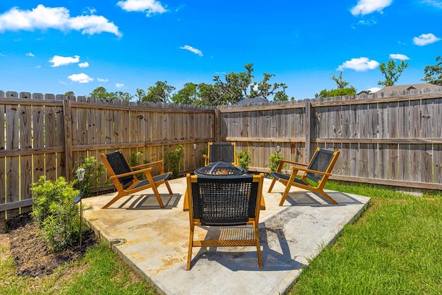 view of patio / terrace featuring an outdoor fire pit and a fenced backyard
