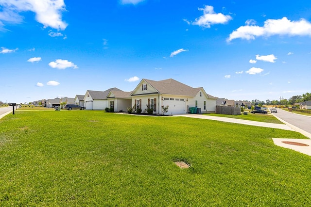 view of front of house with a front lawn, driveway, an attached garage, and a residential view