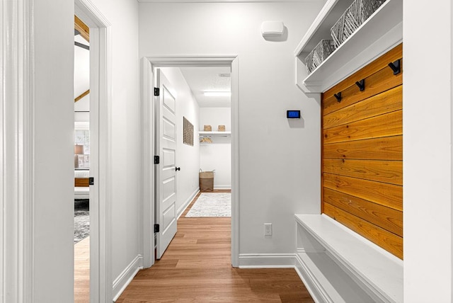 mudroom featuring baseboards and wood finished floors