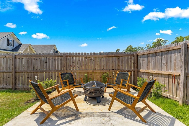 view of patio / terrace featuring a fenced backyard and a fire pit