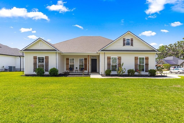 view of front of house featuring a front lawn, a porch, and central air condition unit
