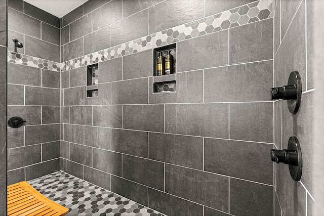 full bathroom with a tile shower