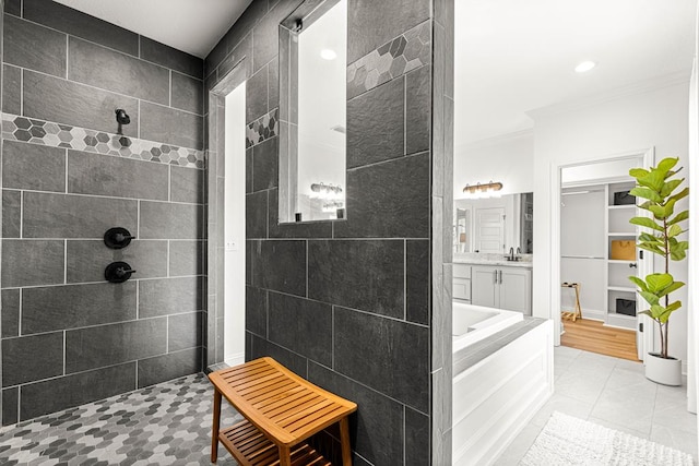 bathroom featuring walk in shower, vanity, ornamental molding, and a garden tub