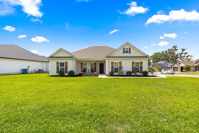 view of front of property with central AC, board and batten siding, and a front lawn