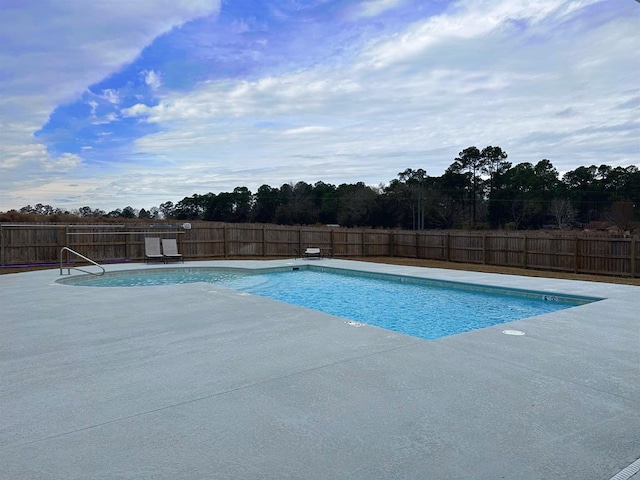 view of swimming pool with a fenced backyard, a patio, and a fenced in pool