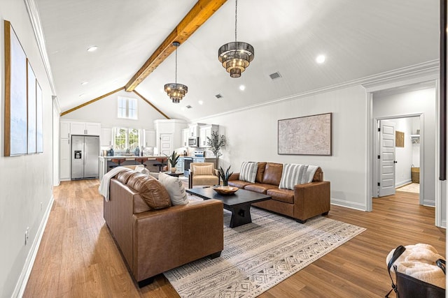 living area featuring light wood finished floors, lofted ceiling with beams, baseboards, and visible vents