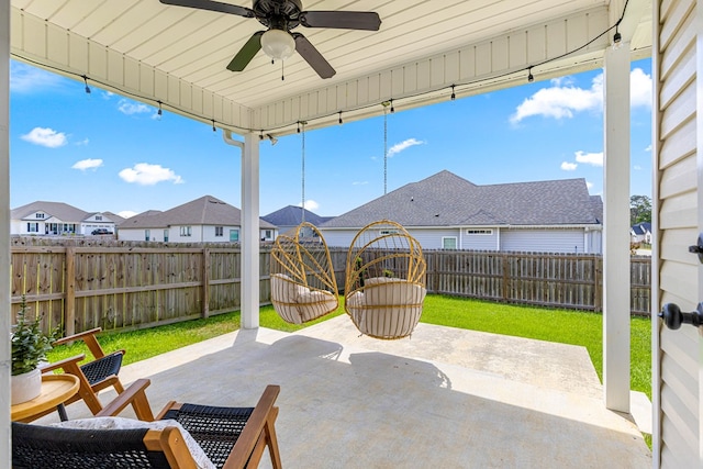 view of patio with a fenced backyard, a residential view, and ceiling fan