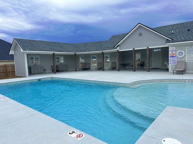 pool featuring a patio area and fence