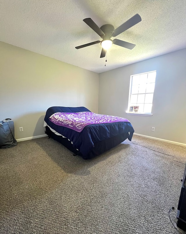 bedroom with ceiling fan, baseboards, and carpet flooring