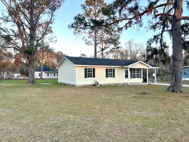 rear view of house with a yard