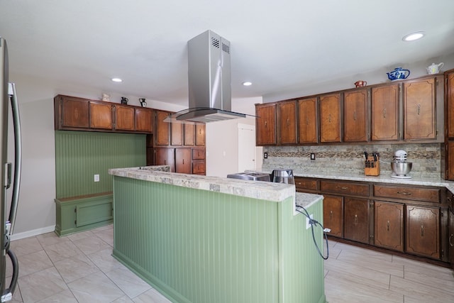 kitchen with tasteful backsplash and island range hood