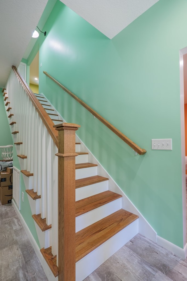 stairway with hardwood / wood-style flooring