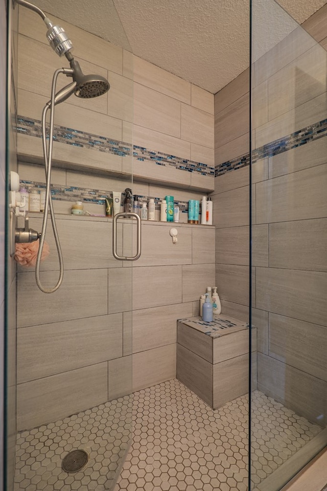 bathroom with a textured ceiling and walk in shower