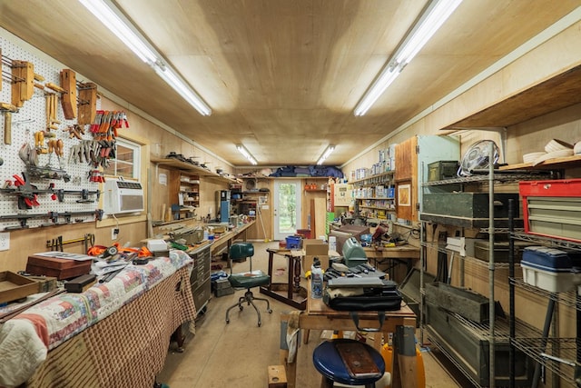 misc room with concrete flooring and a workshop area