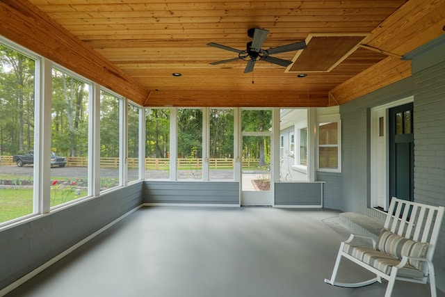 unfurnished sunroom featuring ceiling fan and wooden ceiling