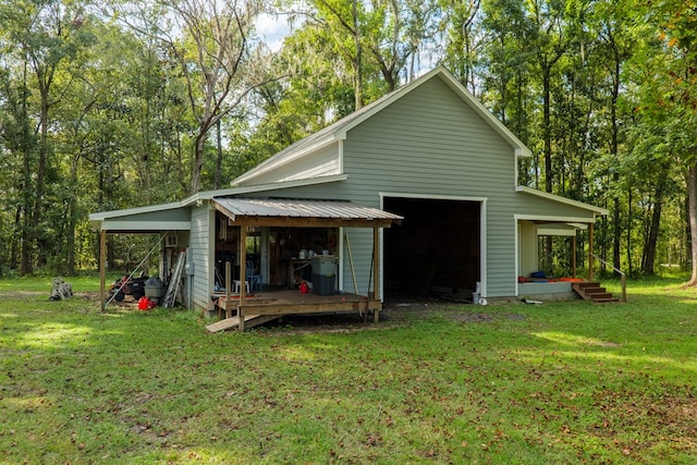 rear view of house with an outdoor structure and a yard