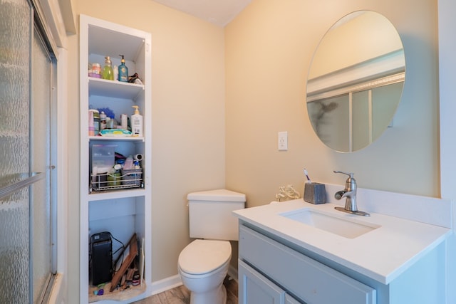 bathroom with hardwood / wood-style flooring, vanity, and toilet