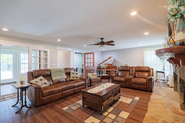 living room featuring wood-type flooring, french doors, a textured ceiling, and ceiling fan