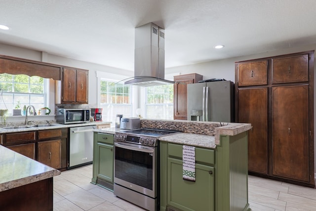 kitchen with island exhaust hood, sink, plenty of natural light, and appliances with stainless steel finishes