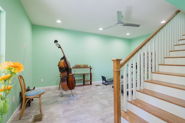 living area with ceiling fan and light hardwood / wood-style floors