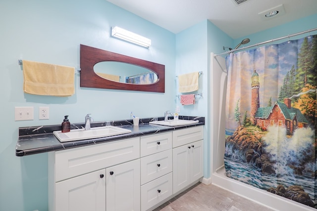 bathroom with a shower with curtain, vanity, and hardwood / wood-style floors