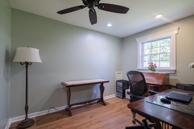 home office with ceiling fan and light hardwood / wood-style flooring