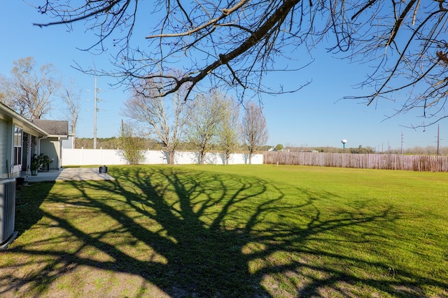 view of yard with a patio area and a fenced backyard