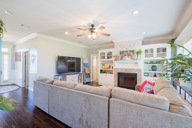 living room with dark wood finished floors, a fireplace, a wealth of natural light, and ornamental molding