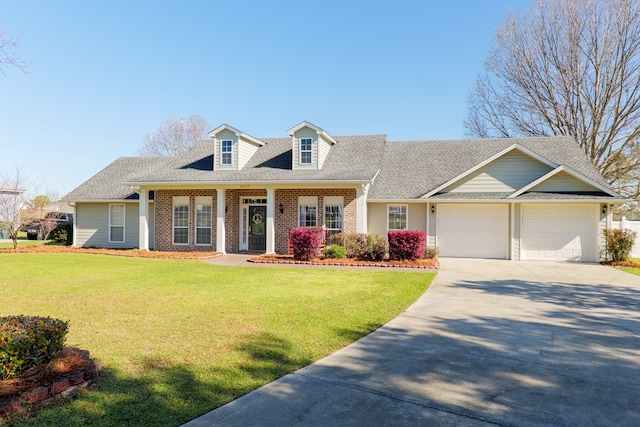 new england style home with a garage, a front lawn, brick siding, and driveway