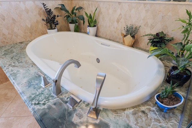 full bathroom featuring tile patterned floors and a jetted tub