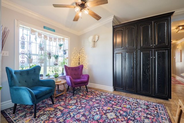 living area featuring light tile patterned flooring, a ceiling fan, baseboards, and ornamental molding