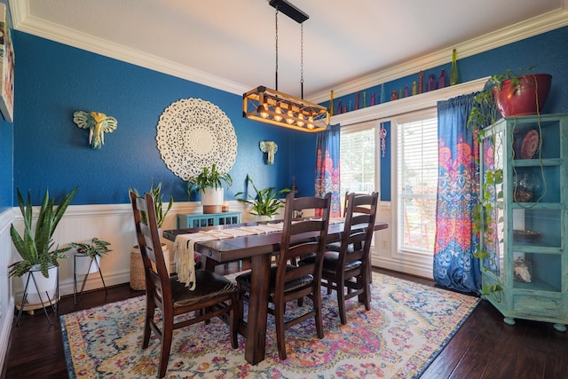 dining space with wainscoting, hardwood / wood-style floors, and ornamental molding