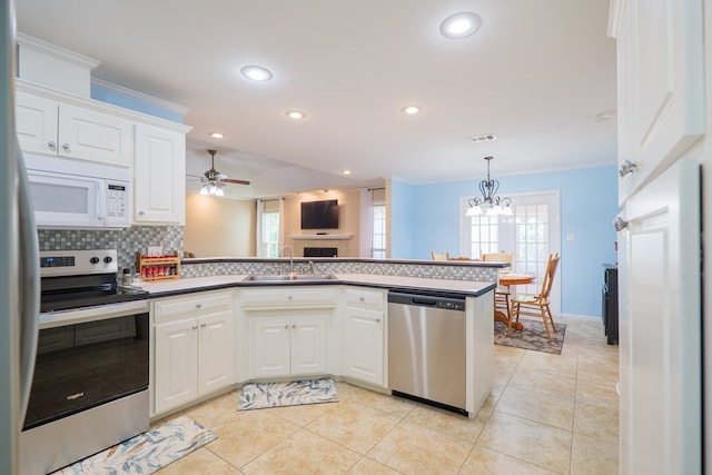 4600 Rustic Ridge Rd, Valdosta, GA 31602 - kitchen featuring stainless steel appliances, healthy amount of natural light, a peninsula, backsplash, and recessed lighting