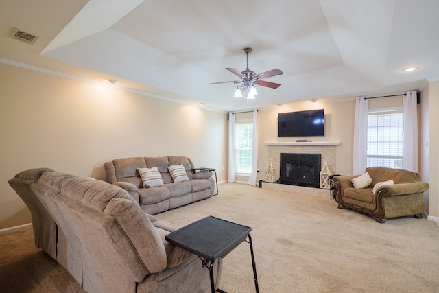 4600 Rustic Ridge Rd, Valdosta, GA 31602 - carpeted living room with a tray ceiling, a ceiling fan, a fireplace, ornamental molding, and recessed lighting