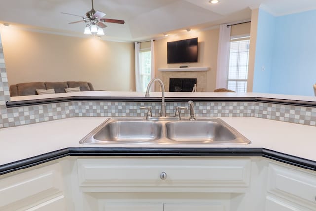 4600 Rustic Ridge Rd, Valdosta, GA 31602 - kitchen featuring open floor plan, a fireplace, white cabinets, and crown molding