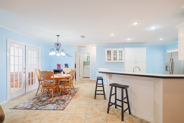 4600 Rustic Ridge Rd, Valdosta, GA 31602 - dining space featuring crown molding, recessed lighting, a chandelier, french doors, and washer / dryer