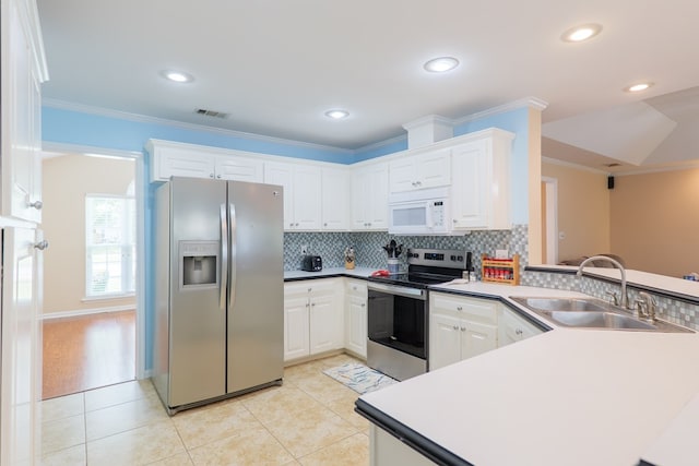 4600 Rustic Ridge Rd, Valdosta, GA 31602 - kitchen featuring stainless steel appliances, a peninsula, crown molding, decorative backsplash, and white cabinets