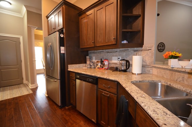 kitchen with stainless steel appliances, light stone counters, dark hardwood / wood-style floors, backsplash, and ornamental molding