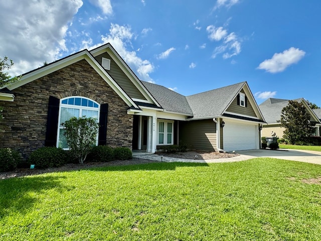 view of front of home with a front yard and a garage