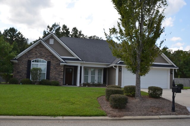 view of front of home featuring a garage and a front yard