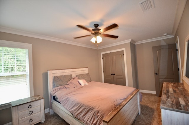 bedroom featuring a closet, dark carpet, ceiling fan, and crown molding