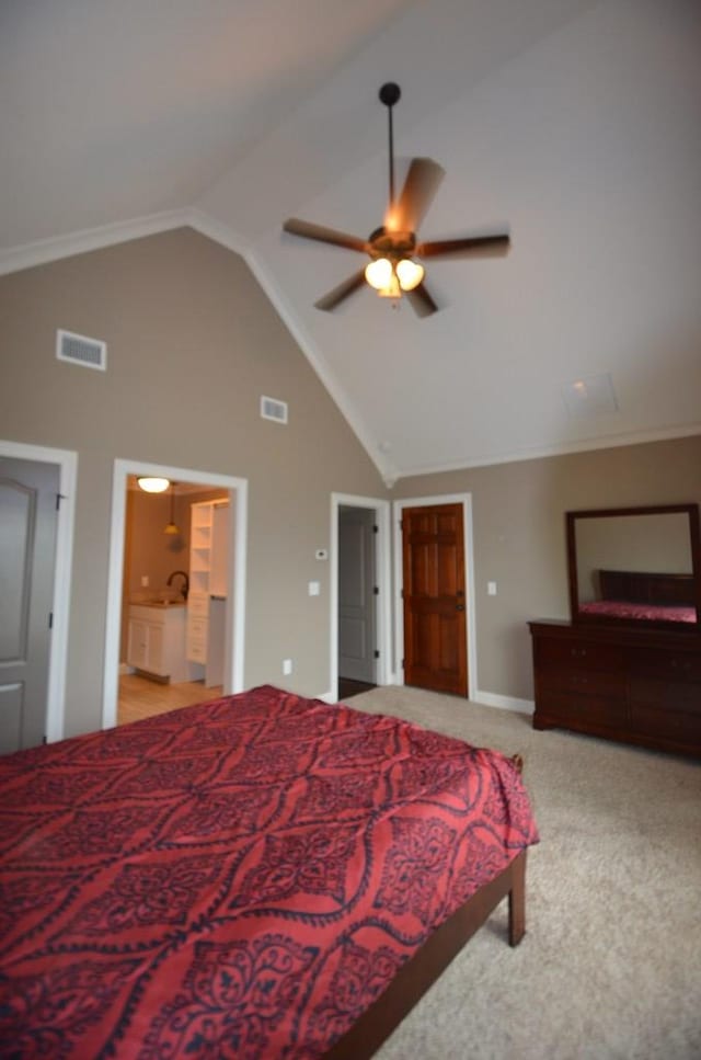 carpeted bedroom featuring high vaulted ceiling, ensuite bath, and ceiling fan