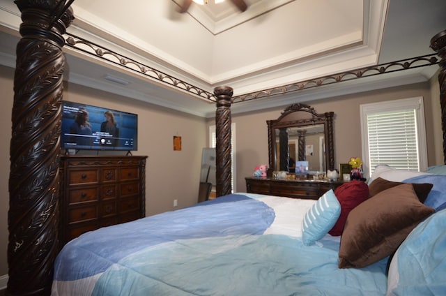 bedroom featuring a high ceiling, ceiling fan, and ornamental molding