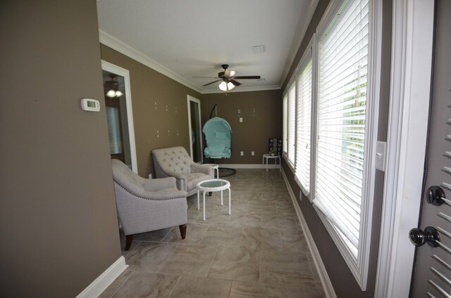 interior space featuring ceiling fan and ornamental molding