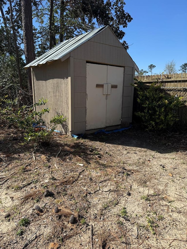 view of shed featuring fence