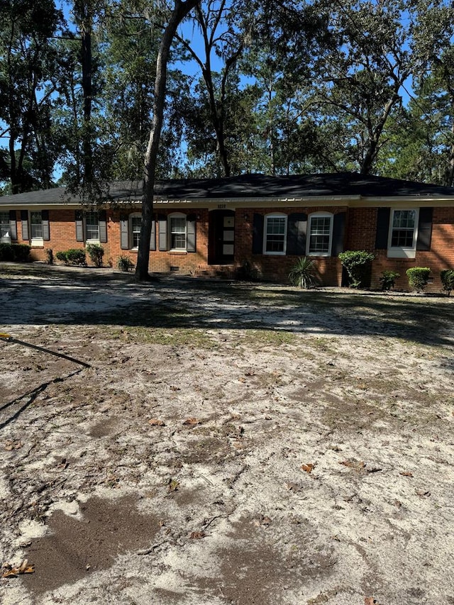 single story home featuring brick siding