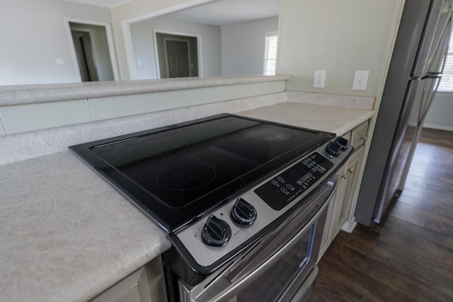 2205 Briarcliff Dr, Valdosta, GA 31602 - kitchen featuring light countertops, stainless steel range with electric stovetop, dark wood-style floors, and freestanding refrigerator