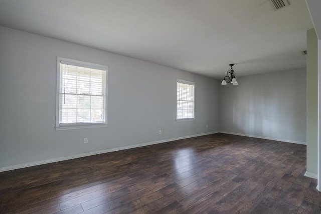 2205 Briarcliff Dr, Valdosta, GA 31602 - unfurnished room featuring dark wood-type flooring, a notable chandelier, baseboards, and visible vents