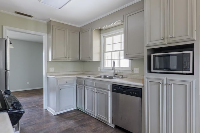 2205 Briarcliff Dr, Valdosta, GA 31602 - kitchen with a sink, dark wood finished floors, appliances with stainless steel finishes, crown molding, and light countertops